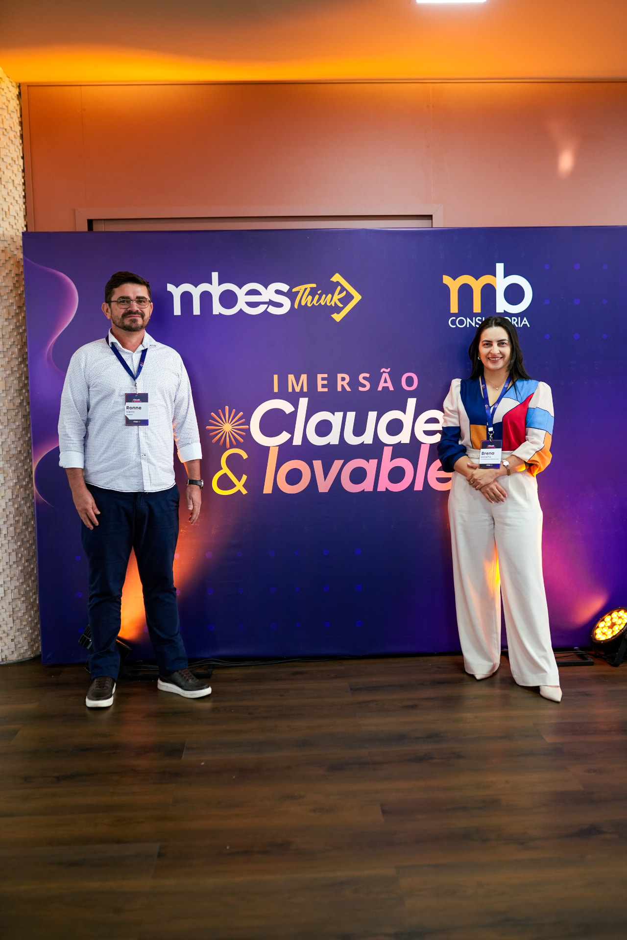 Participantes da Imersão Claude e Lovable ao lado do painel da MB Consultoria